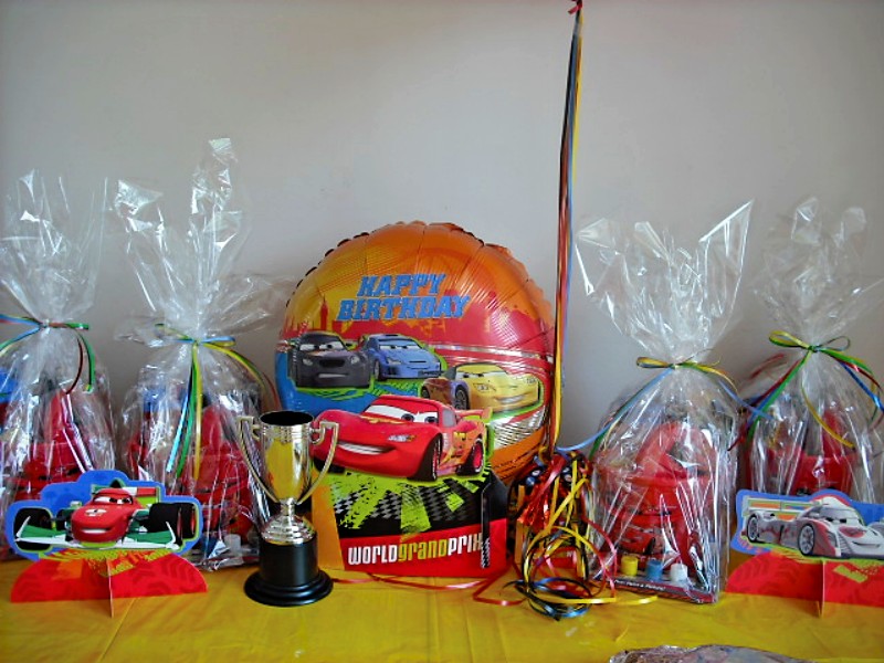 The cake table was setup with balloons, some cars cutouts, and the goodie bags